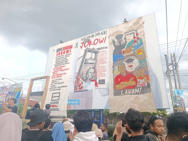 Spanduk besar "Hancurkan dan Adili Rezim Jokowi" dipasang massa aksi di Gejayan, Kabupaten Sleman, Senin (12/2). Foto: A Panji/kumparan