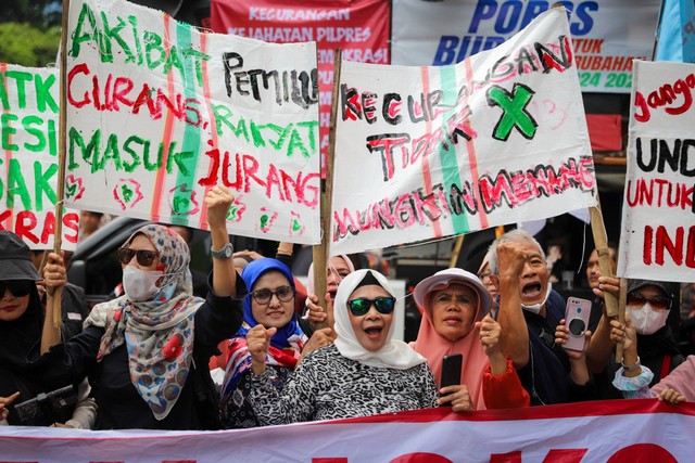 Massa aksi yang tergabung dalam Poros Buruh menggelar demonstrasi di depan Gedung KPU RI, Jakarta Pusat, Rabu (21/2/2024). Foto: Iqbal Firdaus/kumparan