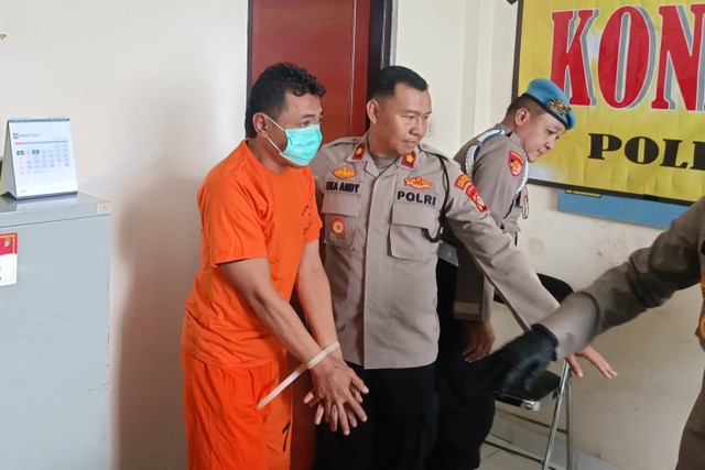 Polisi menujukkan tersangka MM (45) pelaku pencurian laptop di kereta api saat rilis di Polresta Yogyakarta, Kamis (7/3/2024). Foto: Arfiansyah Panji Purnandaru/kumparan