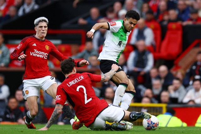 Pemain Liverpool Luis Diaz berebut bola dengan pemain Manchester United Victor Lindelo pada pertandingan Perempat Final Piala FA di Old Trafford, Manchester, Inggris, Minggu (17/3/2024). Foto: Molly Darlington/REUTERS