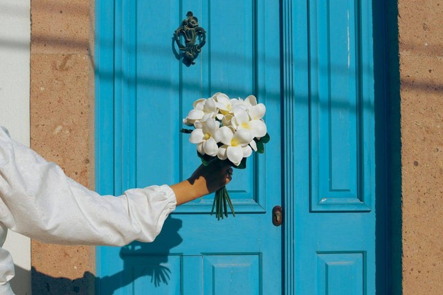 Wanita dengan segenggam bunga. Photo by Fadime Erbass from Pexels: https://www.pexels.com/photo/person-holding-white-flowers-13289844/
