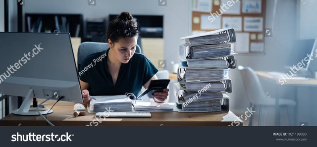 https://www.shutterstock.com/image-photo/young-businesswoman-working-office-stack-folders-1921199030