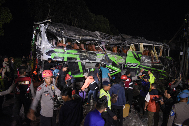 Petugas memeriksa bagian dalam bus pasca kecelakaan yang menewaskan 11 orang, menurut polisi setempat, di Subang, Jawa Barat (11/5/2024). Foto: Timur Matahari / AFP