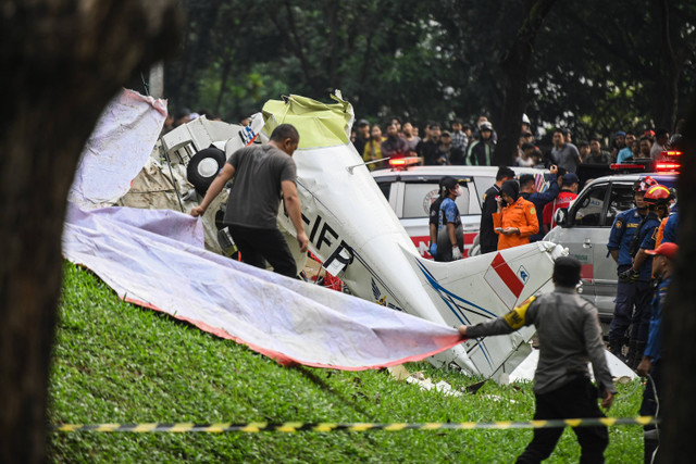 Sejumlah petugas gabungan mengevakuasi pesawat latih Cessna 2006 dengan nomor registrasi PK-IFP milik Indonesia Flying Club (Perkumpulan Penerbang Indonesia) di kawasan BSD, Tangerang Selatan, Banten, Minggu (19/5/2024). Foto: Sulthony Hassanuddin/ANTARA FOTO