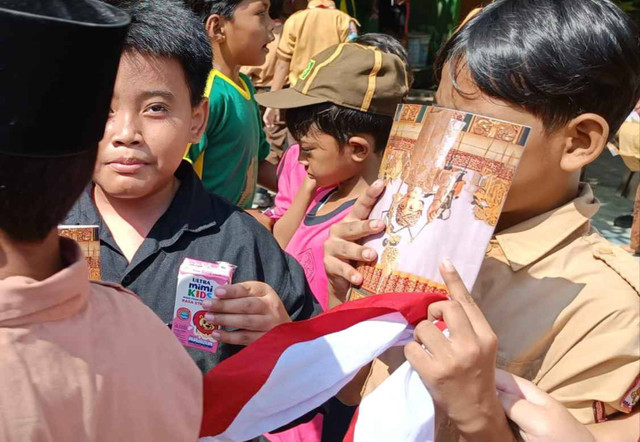 Wakil presiden terpilih sekaligus Wali Kota Solo Gibran Rakabuming Raka sempat membagikan buku tulis bergambar Jan Ethes di SDN Margorejo VI Surabaya, Kamis (6/6/2024). Foto: Farusma Okta Verdian/kumparan