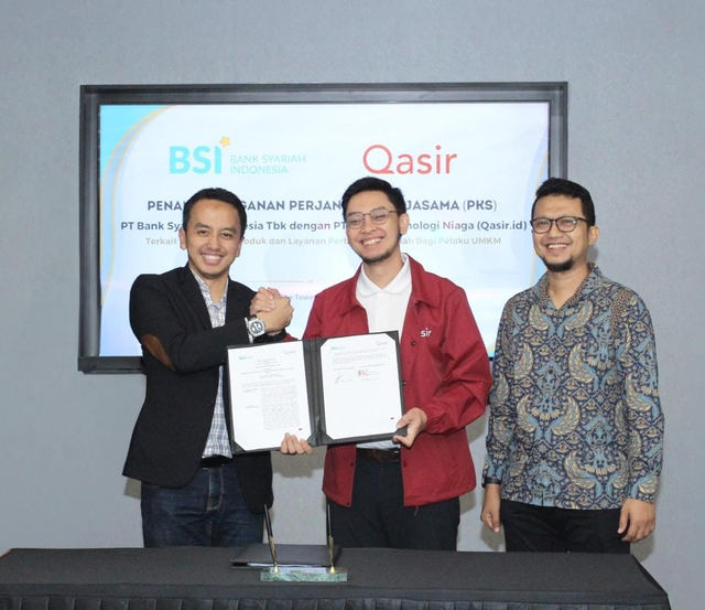 SVP SME Business Group BSI Risqi Widayat (kiri) dan CEO Qasir.id Rachmat Anggara (tengah) dalam penandatanganan perjanjian kerja sama digitalisasi UMKM. Foto: Dok. Istimewa