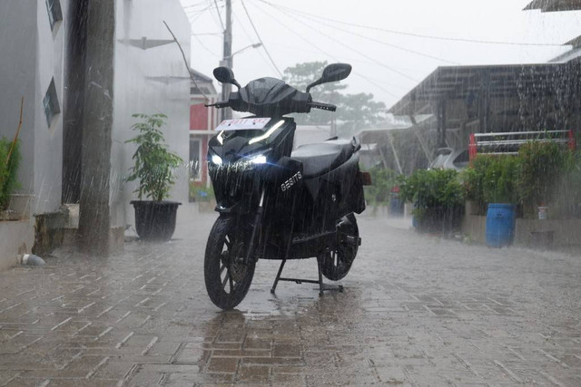 Hujan-hujanan berkendara pakai motor listrik GESITS. Foto: Aditya Pratama Niagara/kumparan