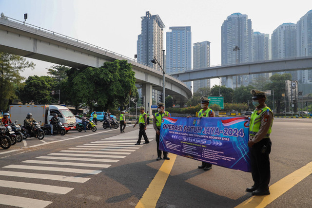 Sejumlah petugas kepolisian memberi himbauan saat penerapan Operasi Patuh di kawasan Tomang, Jakarta, Senin (15/7/2024). Foto: Iqbal Firdaus/kumparan