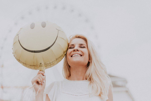 Photo by Julia Avamotive: https://www.pexels.com/photo/woman-holding-a-smiley-balloon-1236678/