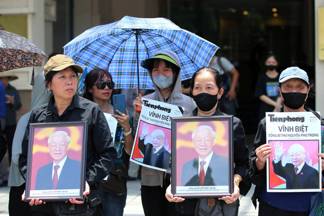 Warga mengikuti prosesi pemakaman Sekertaris Jenderal Partai Komunis Vietnam Nguyen Phu Trong di Hanoi, Vietnam, Jumat (26/7/2024).   Foto: LUONG THAI LINH / POOL / AFP