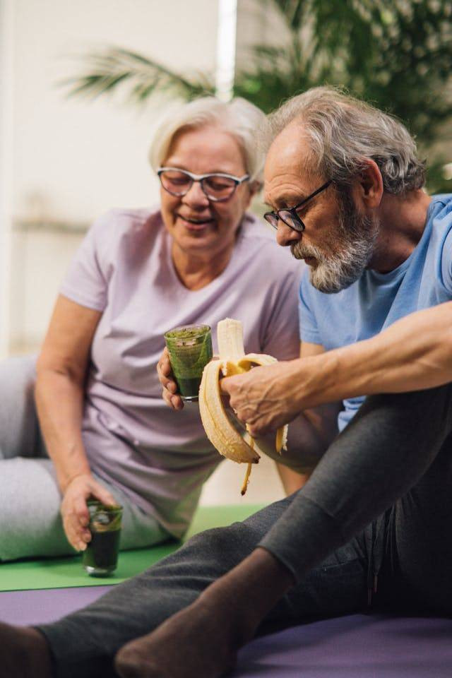 https://www.pexels.com/photo/an-elderly-couple-sitting-on-the-floor-while-having-conversation-6974995/