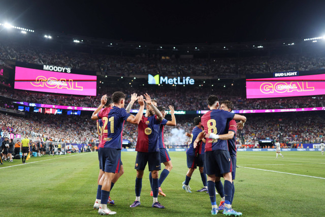 Selebrasi pemain FC Barcelona usai mencetak gol ke gawang Real Madrid pada pertandingan persahabatan di Stadion MetLife, East Rutherford, New Jersey, Minggu (4/8/2024). Foto: Charly Triballeau/AFP