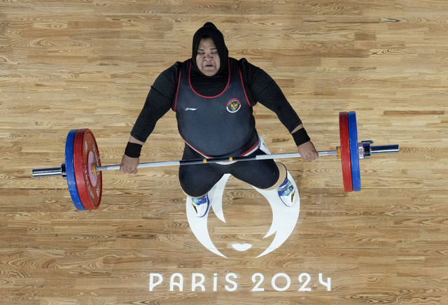 Nurul Akmal dari Indonesia beraksi pada cabang olahraga angkat besi +81kg Putri saat Olimpiade Paris 2024 di South Paris Arena 6, Paris, Prancis, Minggu (11/8/2024). Foto: Dita Alangkara/Pool via REUTERS