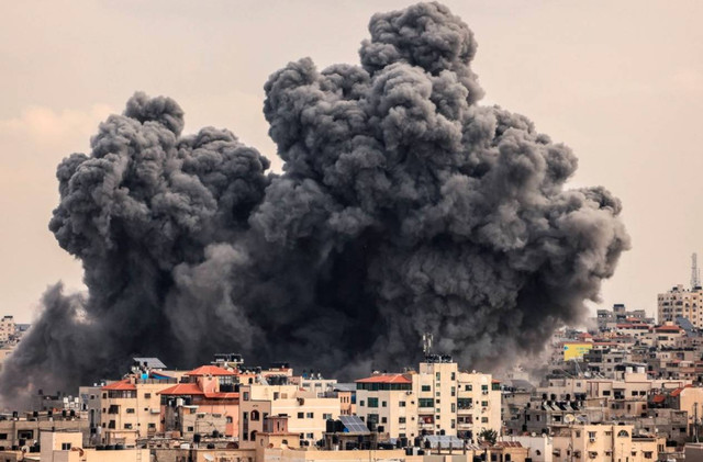 Asap mengepul di atas gedung-gedung selama serangan udara Israel, di Kota Gaza, Senin (9/10/2023). MAHMUD HAMS/AFP