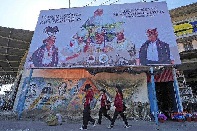 Papan reklame penyambutan Paus Fransiskus terlihat di Dili, Timor Leste, pada 13 Agustus 2024. Foto: Achmad Ibrahim/AP Photo