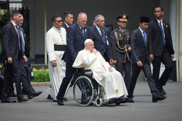 Paus Fransiskus bersama Presiden Indonesia Joko Widodo (kedua kanan) berjalan menuju istana negara setelah melakukan pertemuan pertemuan di Istana Kepresidenan, Jakarta,  Rabu (4/9/2024).  Foto: Achmad Ibrahim/Pool via REUTERS