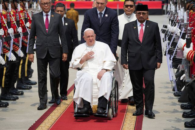 Paus Fransiskus dibawa melewati penjaga kehormatan menjelang keberangkatannya dari Bandara Internasional Soekarno-Hatta Jakarta, Indonesia, Jumat, 6 September 2024.  Foto: Tatan Syuflana/Pool via REUTERS