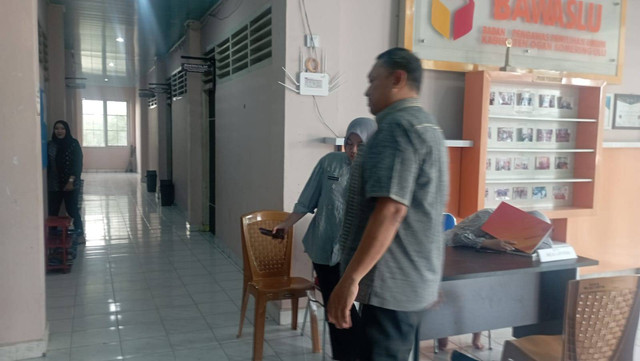 Kepala kantor Ketahanan Pangan OKU Slamet Riyadi berjalan saat hendak masuk keruangan Bawaslu OKU untuk menjalani pemeriksaan oleh Komisioner Bawaslu, Foto : Ist