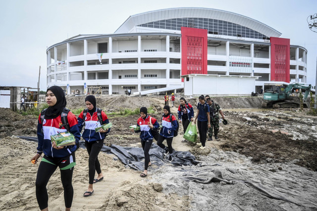 Sejumlah pemain voli PON XXI Aceh-Sumut melewati jalan berlumpur di GOR Bola Voli Indoor Sumut Sport Center, Kabupaten Deli Serdang, Sumatera Utara, Selasa (10/9/2024). Foto: Rivan Awal Lingga/ANTARA FOTO