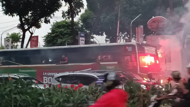 Sejumlah suporter timnas Indonesia menyalakan api suar jelang laga Indonesia vs Australia di kawasan Gelora Bung Karno, Senayan, Jakarta, Selasa (10/9/2024). Foto: Fadlan Nuril Fahmi/kumparan