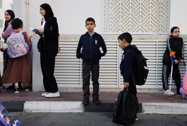 Mahmoud Ajjour, seorang anak yang terluka yang dievakuasi dari Gaza, menunggu bus sekolah di Doha, Qatar. Foto: Ibraheem Abu Mustafa/REUTERS 