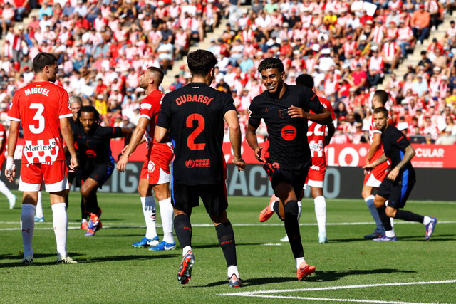 Selebrasi pemain FC Barcelona Lamine Yamal usai mencetak gol ke gawang Girona pada pertandingan Liga Spanyol di Estadi Montilivi, Girona, Spanyol, Minggu (15/9/2024). Foto: Albert Gea/REUTERS 