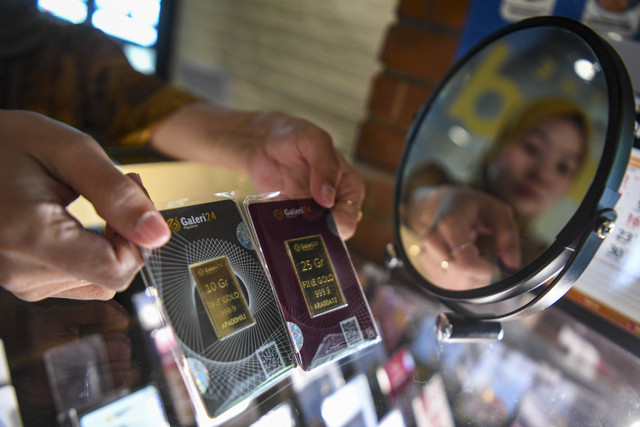 Penjual menunjukan emas logam dagangannya di gerai emas Gade, Jakarta, Selasa (17/9/2024). Foto: Muhammad Adimaja/ANTARA FOTO