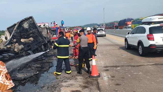 Petugas melakukan pemadaman pada truk pengangkut gulungan plastik terbakar di Jalan Tol Batang KM 358. Foto: Dok. Istimewa