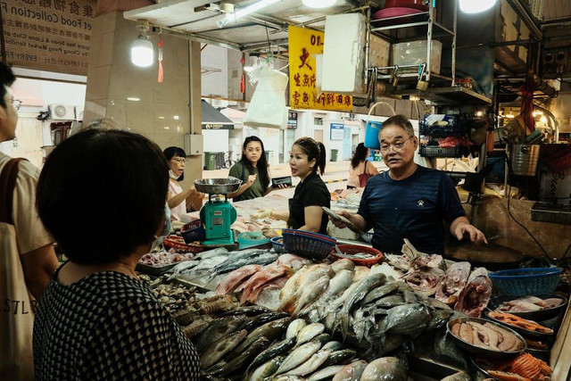 Sumber : https://images.pexels.com/photos/27559503/pexels-photo-27559503/free-photo-of-a-man-standing-in-front-of-a-fish-market.jpeg auto=compress&cs=tinysrgb&w=1260&h=750&dpr=1