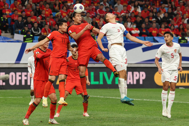 Pemain Timnas Indonesia Jay Idzes berebut bola dengan pemain Timnas China Yuning Zhang pada pertandingan Grup C Ronde Ketiga Kualifikasi Piala Dunia 2026 di Stadion Sepak Bola Remaja Qingdao, Qingdao, China, Selasa (15/10/2024). Foto: Florence Lo/REUTERS