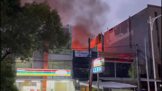 Gedung di seberang Halte TJ Mampang Prapatan terbakar, Kamis (24/10/2024). Foto: Muthia/kumparan