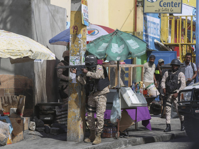 Petugas polisi berpatroli di jalan selama baku tembak antara geng dan polisi di Port-au-Prince, Haiti, Senin, 11 November 2024.  Foto: AP Photo/Odelyn Joseph