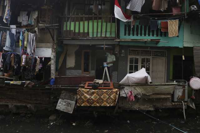 Seorang mengecat rumahnya di kawasan permukiman padat penduduk Tanah Abang, Jakarta, Selasa (12/11/2024). Foto: Alif Bintang/ANTARA FOTO