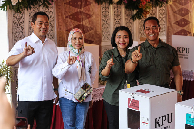 Cagub nomor urut 01 Andika Perkasa bersama istri didampingi pasangannya cawagub Hendrar Prihadi menunjukkan jari kelingkingnya  usai menggunakan hak pilihnya di TPS 3 Lempongsari, Semarang, Jawa Tengah, Rabu (27/11/2024). Foto: Makna Zaezar/ANTARA FOTO