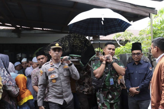 Masyarakat bersama personel TNI/Polri saat membawa jenazah petugas linmas yang meninggal dunia saat bertugas di TPS untuk dikebumikan, di Banda Aceh, Rabu (27/11/2024). Foto: Humas Polresta Banda Aceh-HO/ANTARA FOTO