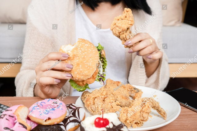 https://www.shutterstock.com/image-photo/unhealthy-woman-over-eating-fast-food-2257686005