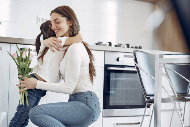 Photo by Gustavo Fring from Pexels: https://www.pexels.com/photo/photo-of-woman-hugging-her-child-while-holding-tulips-4149006/