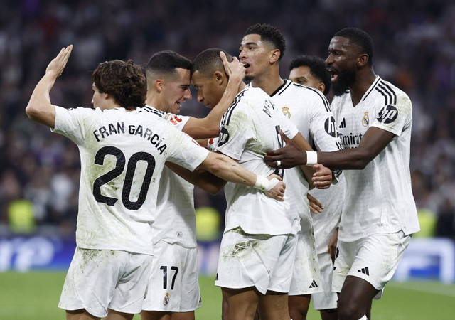 Pemain Real Madrid, Kylian Mbappe, merayakan gol kedua bersama Lucas Vazquez pada pertandingan Liga Spanyol antara Real Madrid melawan Getafe di Santiago Bernabeu, Madrid, Spanyol, Minggu (1/12/2024) malam. Foto: Juan Medina/REUTERS