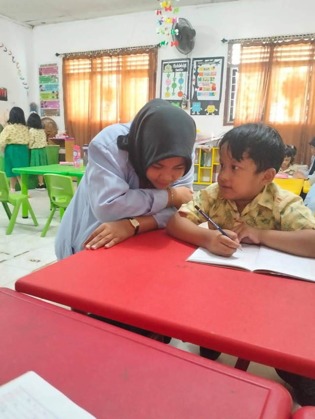 ilustrasi anak sedang berkomunikasi dengan baik bersama kak elsa dan anak mampu  menjawab pertanyaan dan tidak gugup sama sekali. lokasi di tk kartika sekip palembang