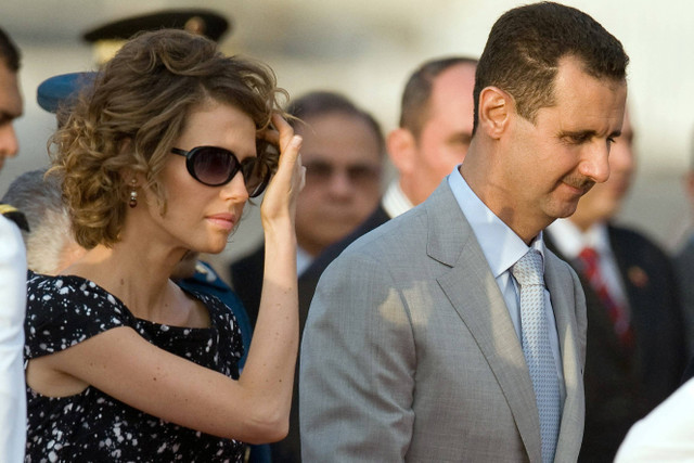 Ibu Negara Suriah Asma al-Assad bersama Presiden Bashar Al-Assad. Foto: Miguel MEDINA / AFP