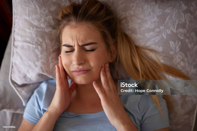 Facial pain after experiencing sleep bruxism, Credit: Hope Connolly on iStock