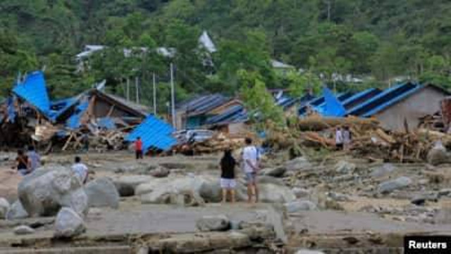 Warga memeriksa rumah-rumah mereka pasca banjir dan tanah longsor di Sentani, Papua Minggu 17/3 (Foto. Antara/Gusti Tanati via Reuters).