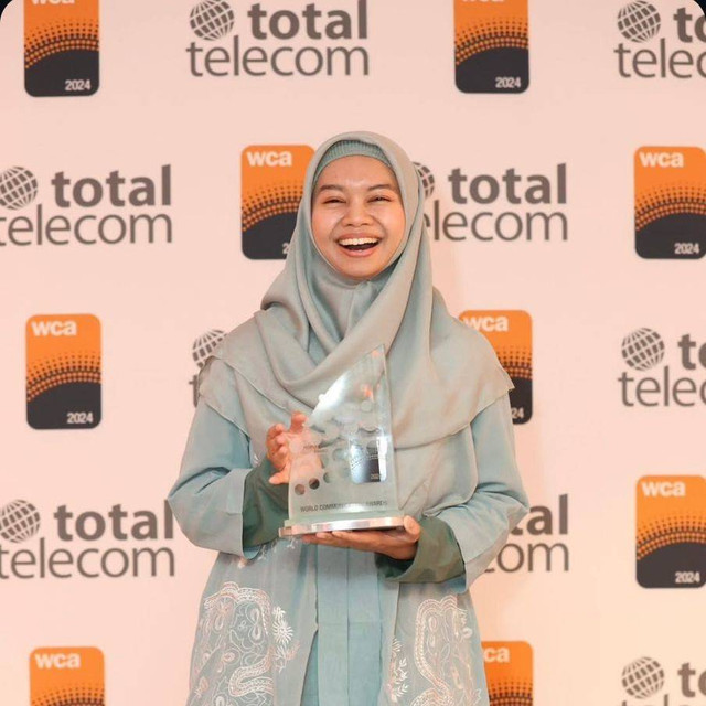 Seorang karyawan Telkomsel menerima trofi pengharagaan World Communication Awards 2024, kategori People & Culture, di London, Inggris, pada 10 Desember 2024, atas keberhasilan Polaris, program inovasi internal yang memberikan ruang pengembangan ide, kolaborasi, serta realisasi inovasi berdampak. Foto: Dok. Telkomsel