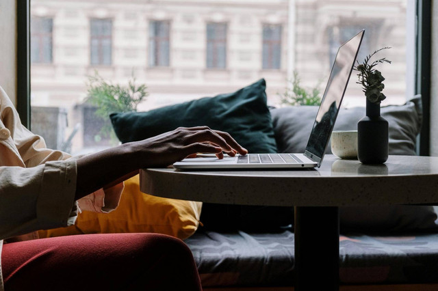 (Sumber : https://www.pexels.com/photo/person-in-red-pants-sitting-on-couch-using-macbook-5054213/)