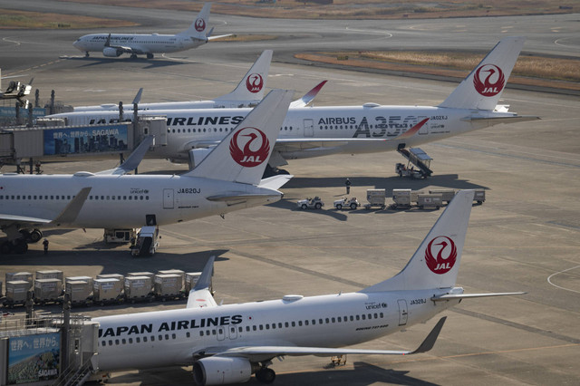 Pesawat penumpang Japan Airlines terlihat di landasan pacu Bandara Haneda di Tokyo pada 26 Desember 2024. Foto: Yuichi Yamazaki/AFP 