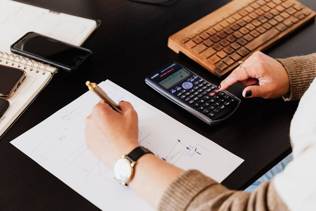 Photo by Photo By: Kaboompics.com: https://www.pexels.com/photo/bookkeeper-writing-down-on-paper-while-using-calculator-4476375/