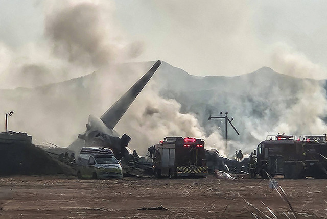 Petugas pemadam kebakaran melakukan operasi pemadaman di sebuah pesawat yang melaju kabur di Bandara Internasional Muan di Muan, Provinsi Jeolla Selatan, Korea Selatan, Minggu (29/12/2024). Foto: Yonhap via REUTERS