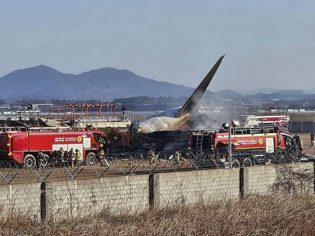 Petugas pemadam kebakaran melakukan operasi pemadaman di sebuah pesawat yang melaju kabur di Bandara Internasional Muan di Muan, Provinsi Jeolla Selatan, Korea Selatan, Minggu (29/12/2024). Foto: Yonhap via REUTERS