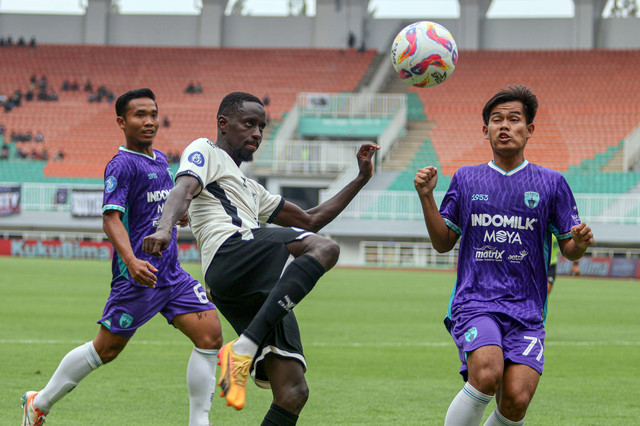 Pemain Persita Badrian Ilham berebut bola dengan pemain PSM Makassar Latyr Fall pada pertandinggan Liga 1 di Stadion Pakansari, Kabupaten Bogor, Jawa Barat, Minggu (29/12/2024). Foto: Yulius Satria Wijaya/ANTARA FOTO