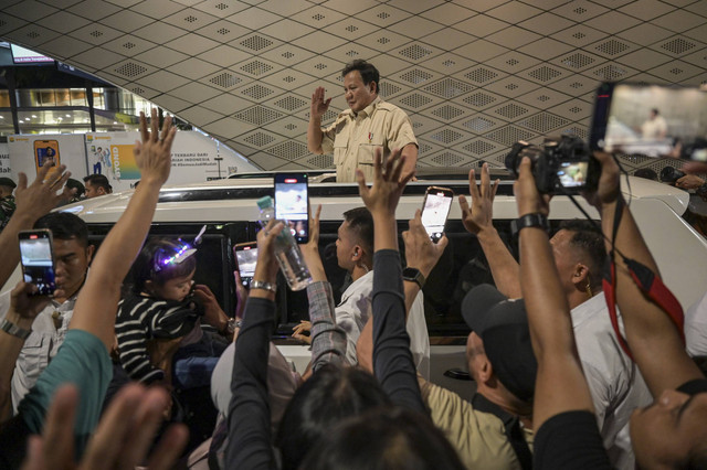 Presiden Prabowo Subianto (tengah) menyapa warga dari atas mobilnya saat car free night di kawasan Bundaran HI, Jakarta, Selasa (31/12/2024).  Foto: Fauzan/ANTARA FOTO